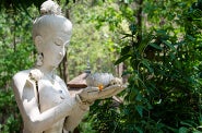 A Buddha holds a lotus flower.