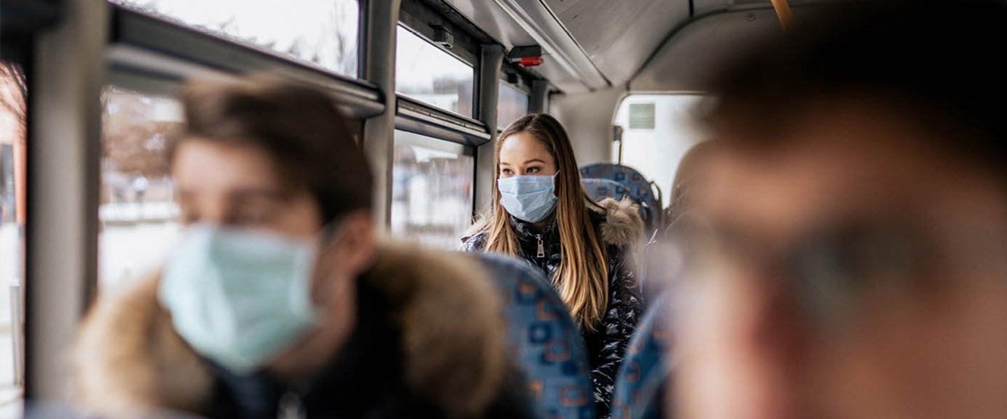 People on bus wearing face masks