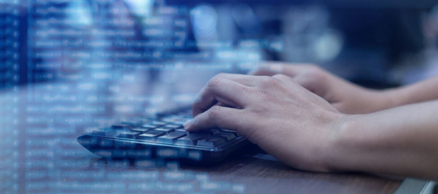 Close up of hands typing on a keyboard