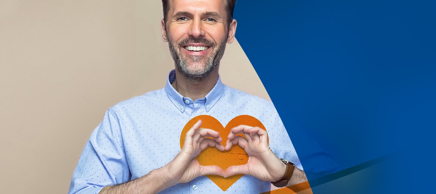 Image of a man making shape of a heart on his chest