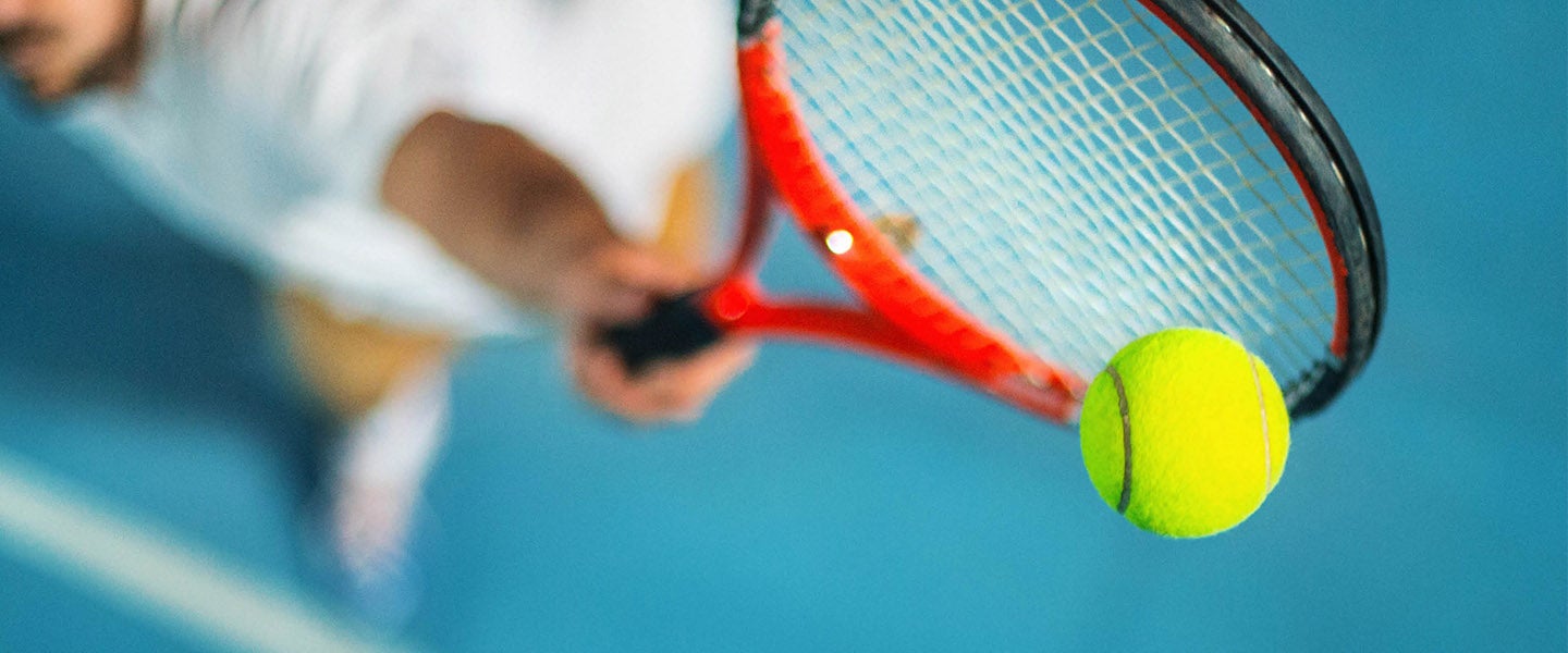 Tennis player hitting tennis ball