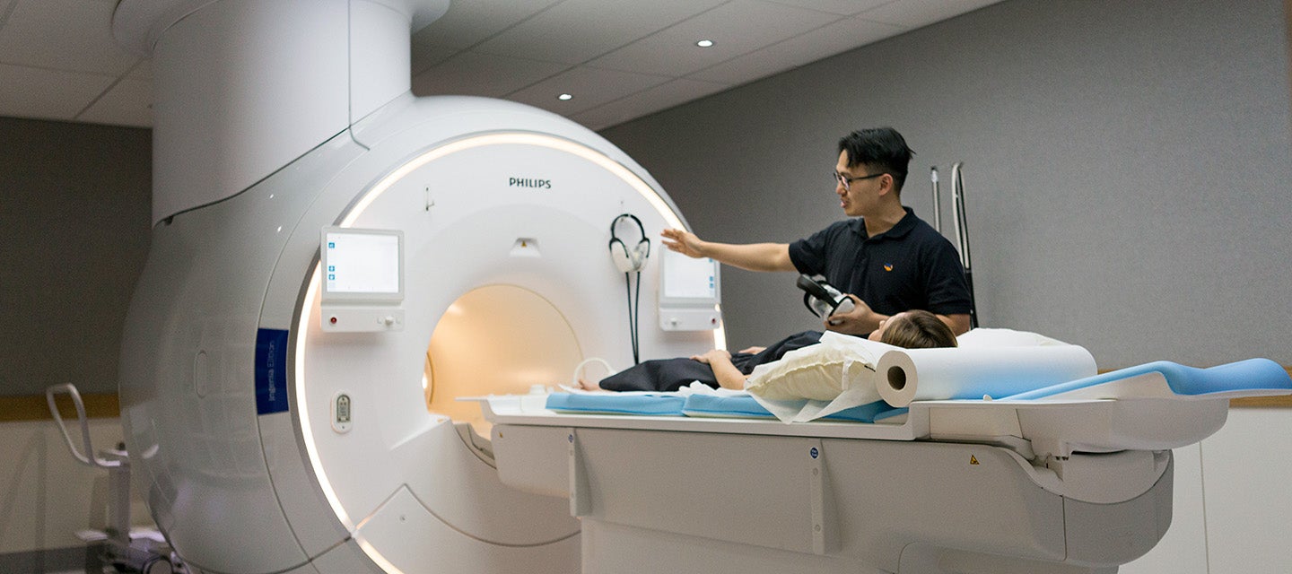 An I-MED technician assists a patient undergoing an MRI scan 