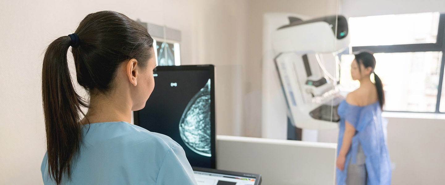 Woman having mammogram with screen in foreground