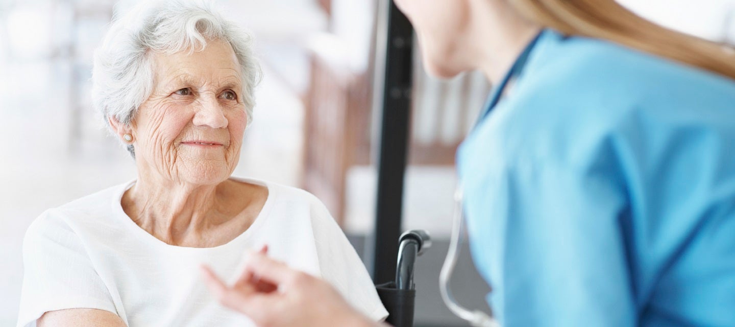 Elderly patient being comforted by nurse