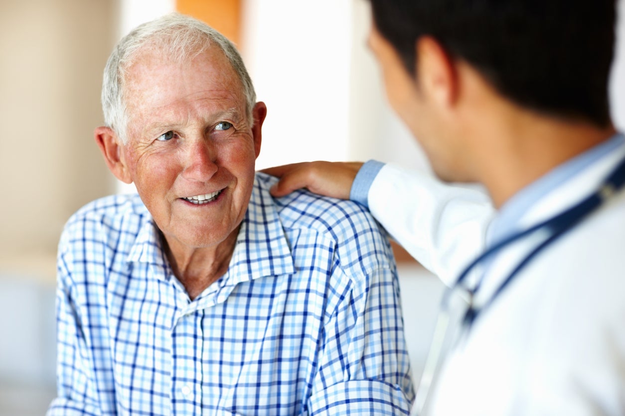 Doctor comforting elderly man