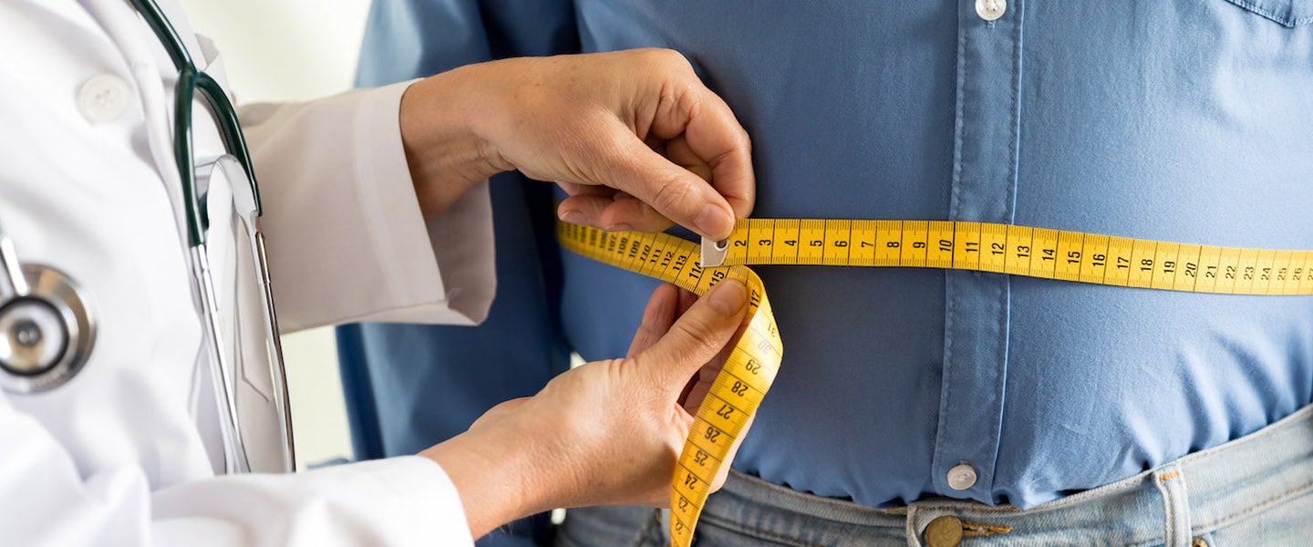 Overweight man being measured