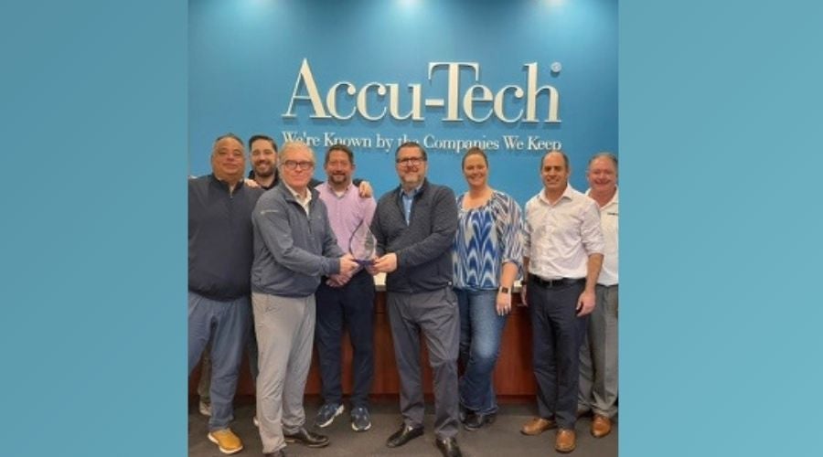 Group photo of Chatsworth Products representatives presenting an award to the Accu-Tech team in front of the Accu-Tech logo.