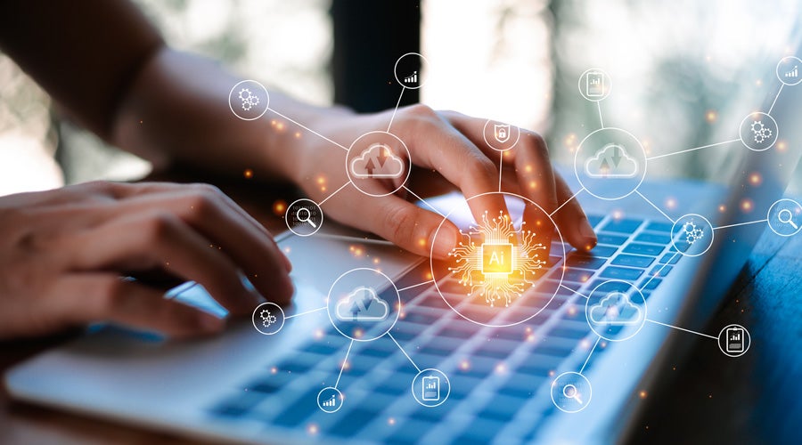 Hands typing on a laptop keyboard, surrounded by glowing icons representing AI and cloud computing.