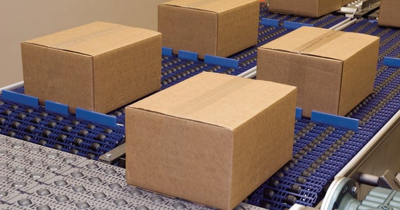 Brown cardboard case packages on roller top conveyors