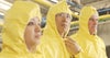 Food safety workers in yellow jumpsuits