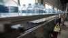 Bundles of bottle water on roller and friction top conveyor belts