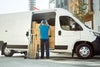 Worker unloading boxes from cargo van