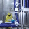 Worker cleaning a DirectDrive Stacker spiral