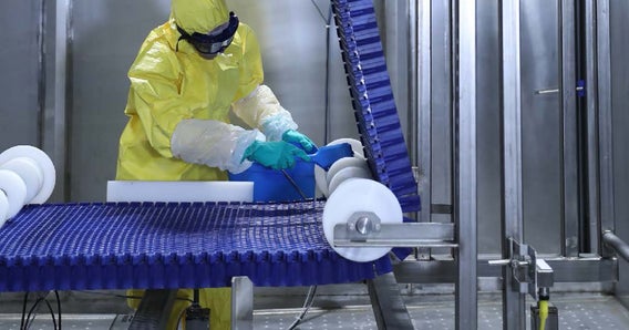 Worker cleaning a DirectDrive Stacker spiral
