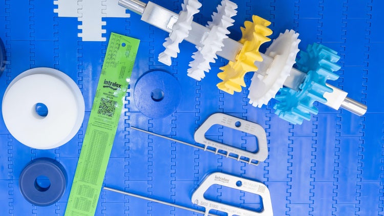Various OneTrack tools and components arrayed on blue conveyor belt