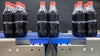 Bundled six packs of cola in PET bottles on Series 560 tight transfer belt