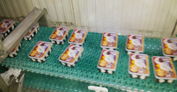 Ice cream containers on conveyor belt