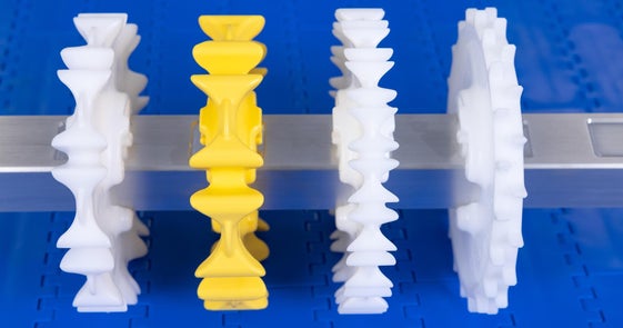 White and yellow CleanLock sprockets on conveyor shaft