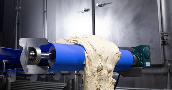 Raw dough rolling off a LugDrive 8140 conveyor belt