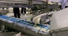 Corn kernels are fed onto a ThermoDrive Embedded Diamond Top belt on an incline-to-surge Z-conveyor