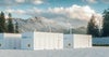 Large storage units for battery-based energy storage, alongside solar panels and windmill turbines