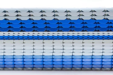 Side profile of several different Intralox Heavy-Duty Edge (HDE) conveyor belts stacked atop each other