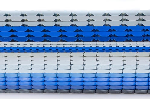 Side profile of several different Intralox Heavy-Duty Edge (HDE) conveyor belts stacked atop each other