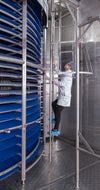 Worker climbing ladder in DirectDrive spiral freezer