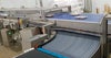 AIM Switch feeding meat tray packs to Intralox Series 2100 ZERO TANGENT conveyor belt