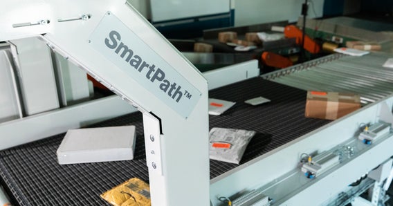 SmartPath Singulator and Gapper with packages and signage