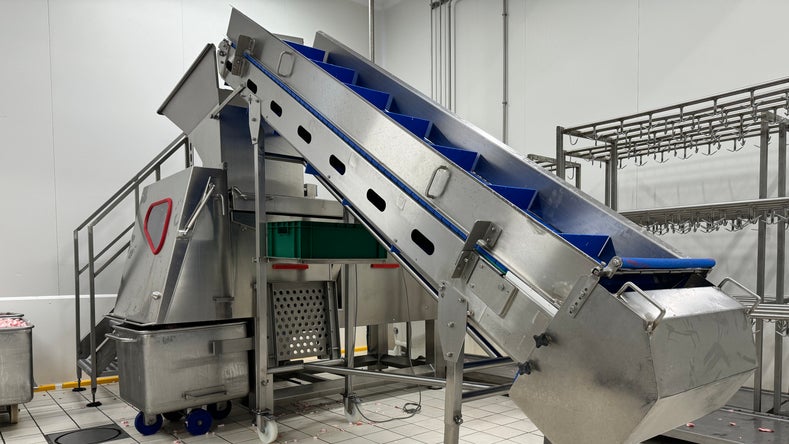 An elevator in Salumficio Mec Palmieri's facility is equipped with Intralox S800 Open Hinge Flat Top belting with Heavy-Duty Edge in blue PK