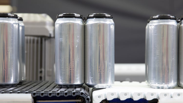 Aluminum cans on conveyor transfer with no dead plates