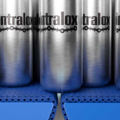 Cans aligned on an Intralox S570 belt