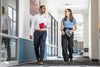 Man and woman walking down hallway