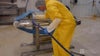 Commercial Food Sanitation training | worker cleaning conveyor