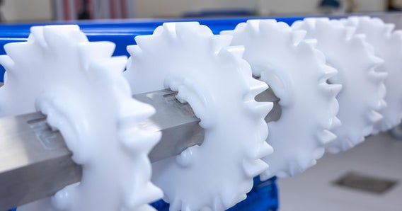 White CleanLock sprockets on conveyor shaft