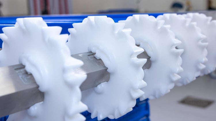 White CleanLock sprockets on conveyor shaft