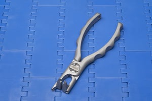 Intralox rod remover tool on top of blue modular belt