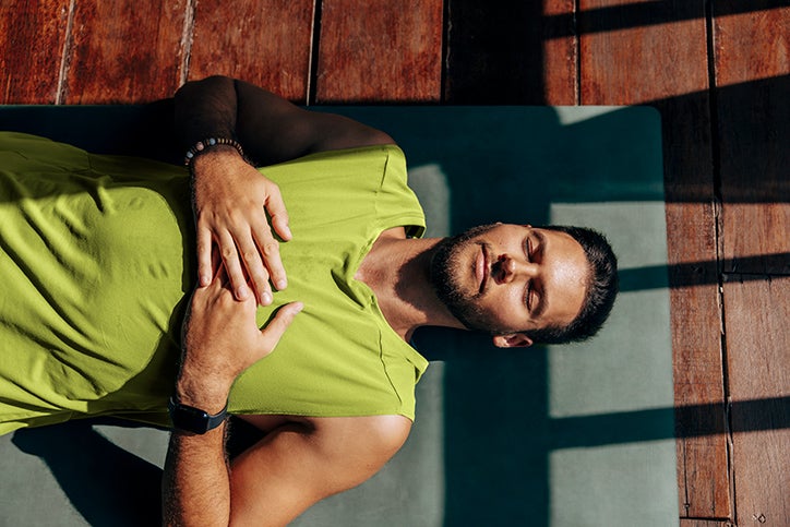 Man laying down dealing with stress