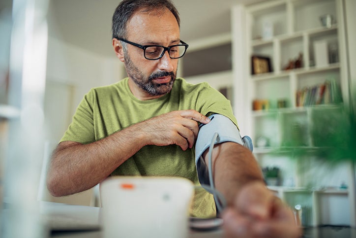 Man with beard and glasses doing blood pressure check