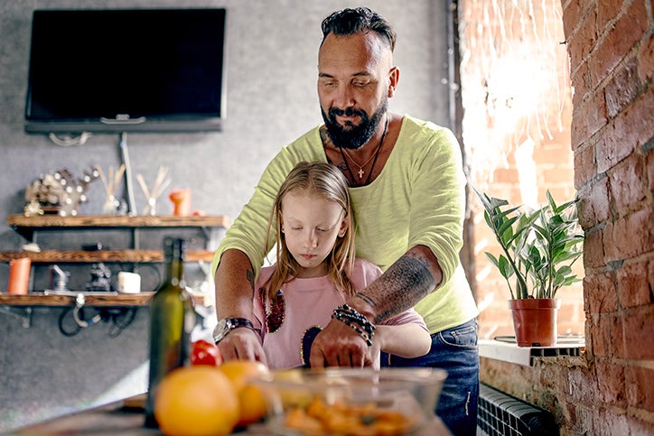 A man cooking with his daughter