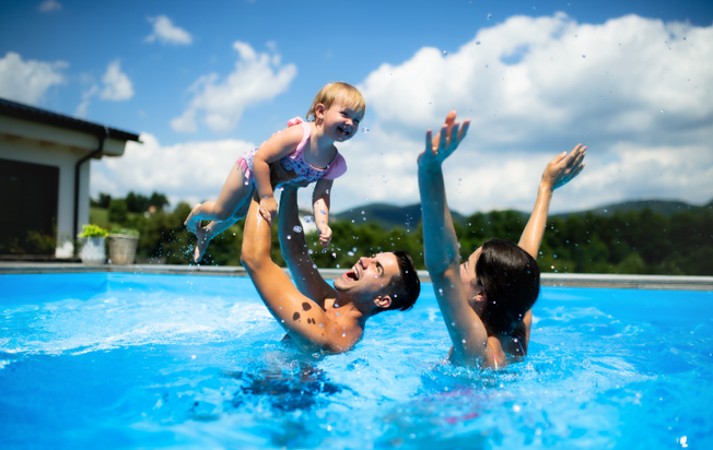 happy family playing in a pool