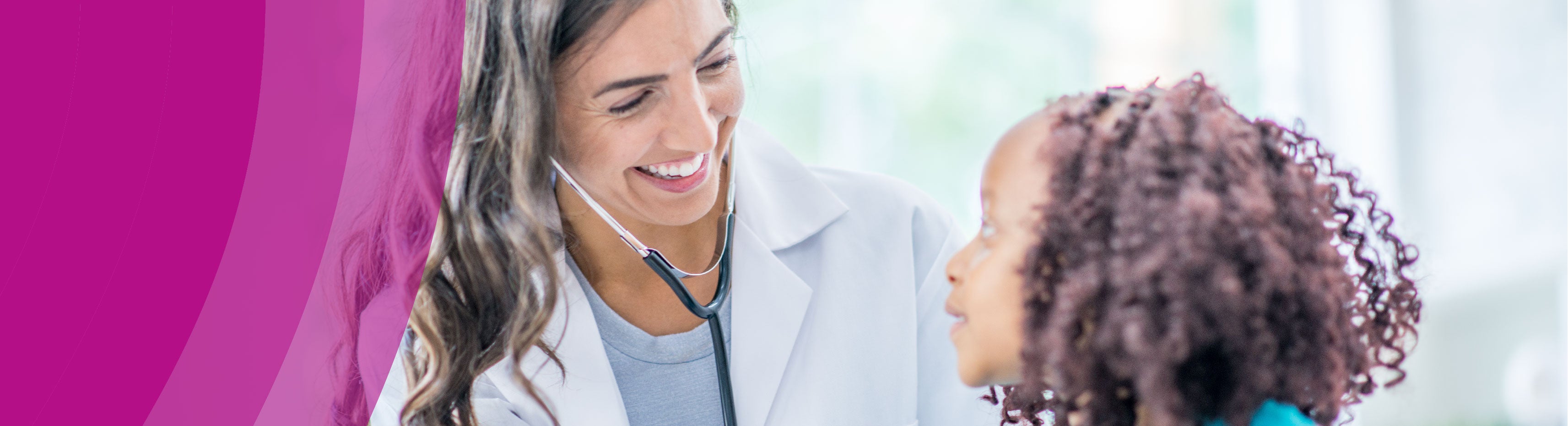 Healthcare worker and and young girl smiling at each other