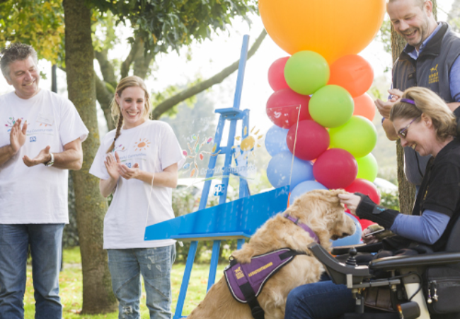 People happy looking at service dog