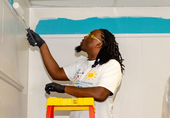 Volunteer in Oklahoma painting a classroom
