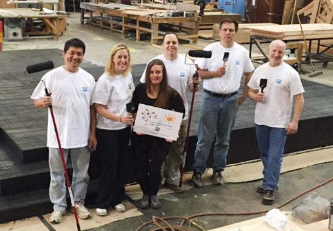 Volunteers on rooftop with painting supplies