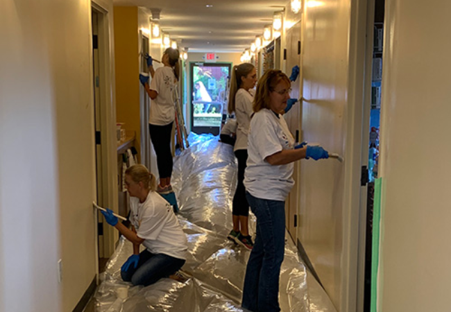 group of volunteers painting hallway white in Mt. Gilead, Ohio