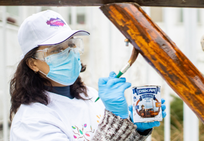 girl staining wood