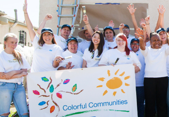 volunteers holding a colorful communities sign in Los Angeles 