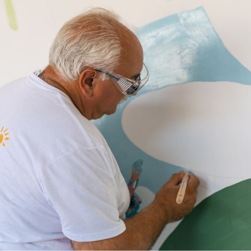 man painting wall mural 
